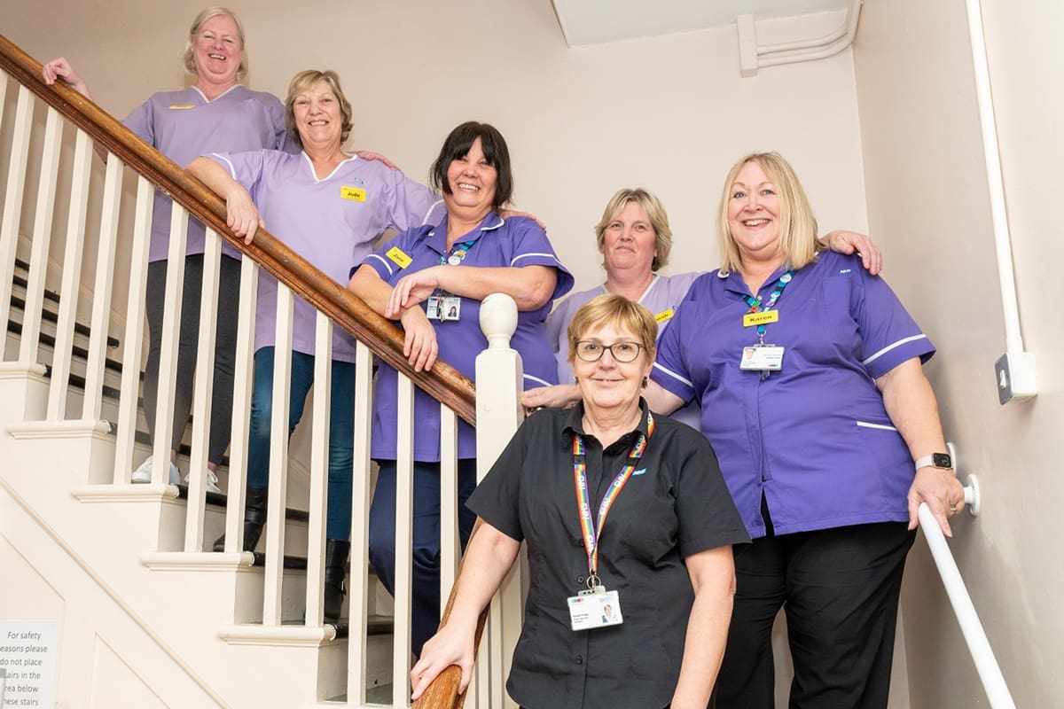 Lydney hospital facilities team on stairs